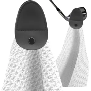 Detailed view of microfiber golf towel featuring a magnetic grey leather attachment strap