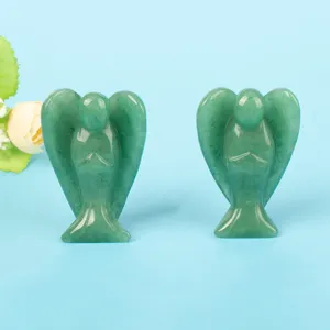Close-up detail of two natural green aventurine quartz angel figurines for home decor