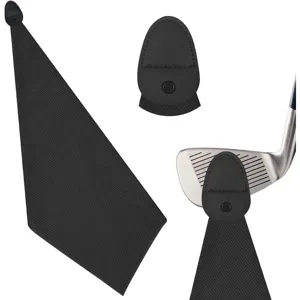 Detail view of black microfiber golf towel with magnetic clip attached to a club