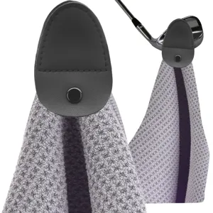 Close-up detail of gray microfiber magnetic golf towel clip attached to a golf club head