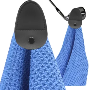 Detailed shot of microfiber golf towel blue waffle texture and magnetic leather clip