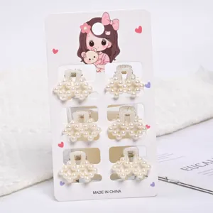 Set of six elegant mini faux pearl hair claw clips on a cute cartoon display card