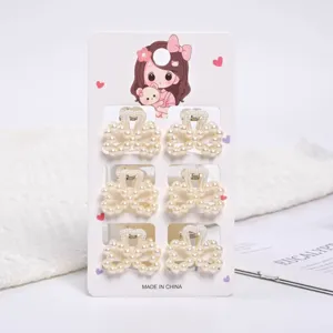 Detailed view of 6 pieces mini cream white pearl bow-shaped hair claw clips on card