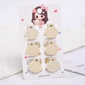Detail view of 6 mini pearl hair claw clips on display card for elegant hair styling