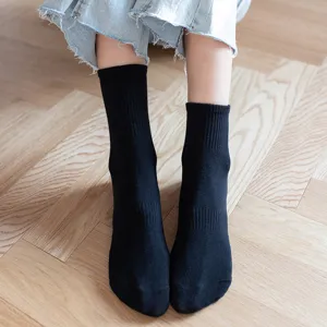 Classic black mid-calf socks for women and men, versatile cotton crew socks for daily wear.