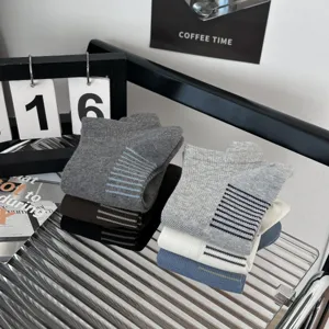 Detailed view of men's striped cotton socks stacked neatly on a modern lifestyle desktop.