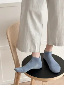 Detailed shot of men's breathable mesh ankle socks in light blue, showing heel tab and knit texture.