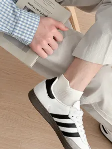 Breathable men's white cotton socks with comfortable low-cut design for daily casual wear.