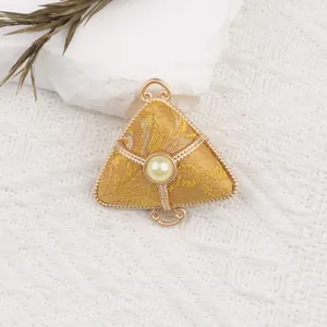 Detailed view of traditional Chinese Song brocade zongzi pendant with gold trim and pearl.