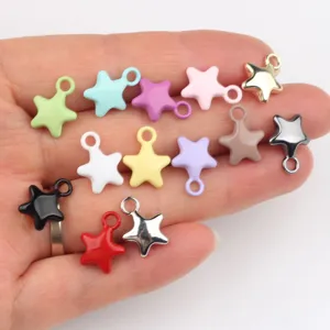 Close-up detail of colorful star pendants, showing vibrant enamel colors and metal finishes.