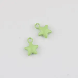 Close-up detail view of light green alloy painted star pendant charm for DIY jewelry.