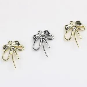 Gold and silver alloy bow pendant charms, perfect for DIY jewelry making and bracelet accessories.