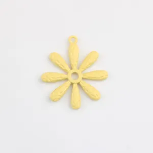 Close-up view of the yellow painted daisy alloy pendant, perfect for DIY jewelry making.