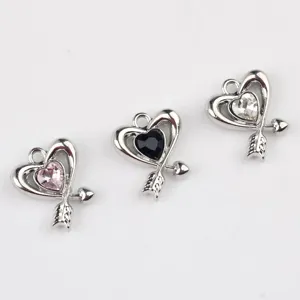 Detail view of heart shaped alloy zirconia charms with arrow design for DIY jewelry making.