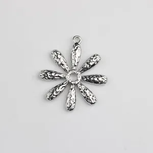 Silver metal daisy pendant detail view, hammered petal texture for DIY jewelry making accessories.