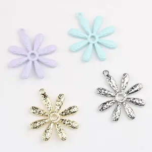 Detailed view of colorful alloy daisy charms, perfect for handmade DIY jewelry making.
