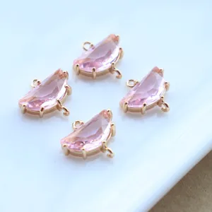 Close-up of gold-plated pink crystal semi-circular double loop charms for DIY jewelry making.