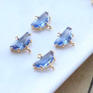 Close-up of half-round blue crystal gold-plated double loop pendant DIY jewelry component.