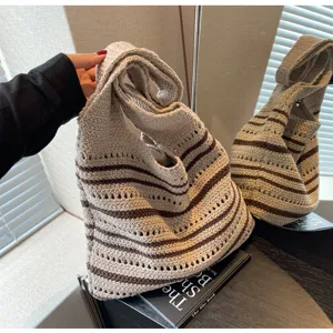 Detailed close-up shot of knitted striped hobo tote bag, casual daily shoulder bag for women.