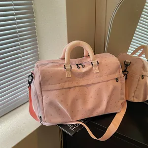 Detailed view of the pink star pattern travel duffel bag showing large capacity and handles.