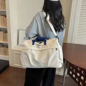 Casual large capacity travel duffel bag, stylish canvas shoulder tote bag for women daily use.