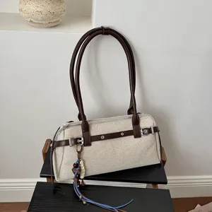 Sac bandoulière rétro en toile avec lanières en cuir marron, boucles métal et charm.