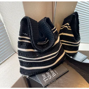 Black and white striped knit tote bag detail, featuring soft crochet texture and spacious design.