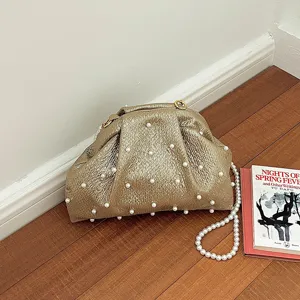 Stunning metallic textured pearl clutch bag, elegant evening shoulder bag detail view.