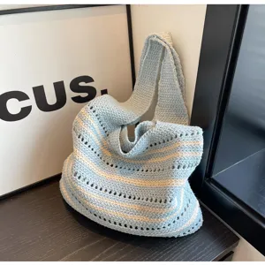 Detailed view of the light blue crochet shoulder bag with white stripes, casual tote design.