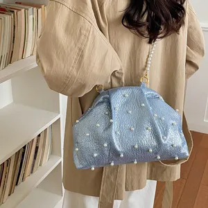 Stylish blue crinkled pearl shell handbag for women, elegant crossbody shoulder bag.