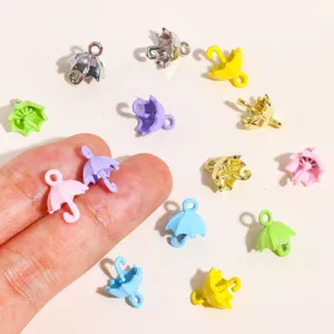 Closeup of colorful 3D umbrella enamel alloy charms for DIY handmade necklaces and bracelets.