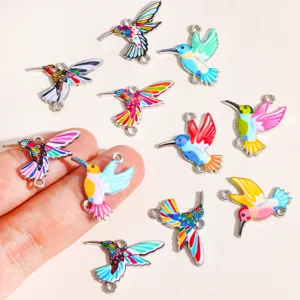 Close-up of colorful enamel hummingbird charms, perfect for DIY handmade jewelry and crafts.