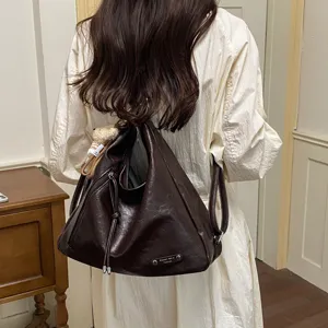 Dark brown PU leather multi-function hobo backpack, versatile commuter shoulder and crossbody bag detail view.