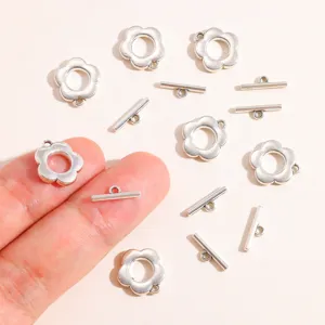 Close-up of DIY metal flower toggle clasps, alloy jewelry making accessories findings details.