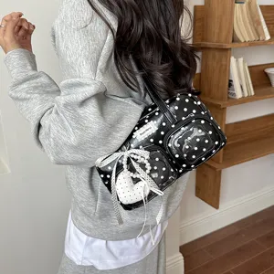 Casual black and white polka dot underarm shoulder bag with clear front pockets and cute ribbon.