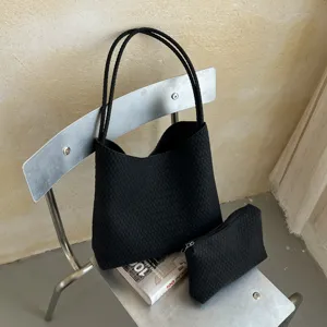 Black woven leather tote bag with matching pouch, stylish large capacity shoulder bag.