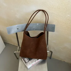 Brown woven leather tote bag detail, vintage style shoulder bag for daily commuting use.