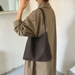 Woven leather shoulder bag detail, dark brown retro tote, stylish everyday commute purse.
