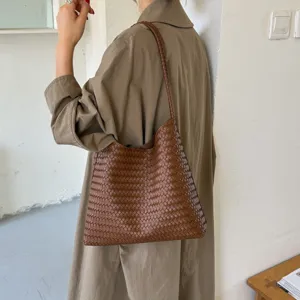 Detail view of the retro woven leather shoulder bag, stylish large capacity commuter tote for women.