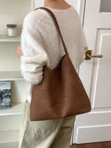 Vintage brown woven shoulder bag for women, large capacity stylish tote bag for daily commute.