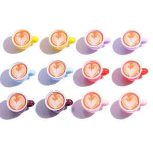 Mini resin coffee cup charms detail view, cute latte art flat lay for DIY jewelry making.