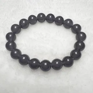 Quartzite jade round bead bracelet detail view showing smooth dark purple texture and polish.