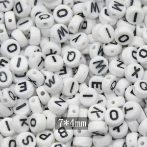 Closeup of white acrylic alphabet flat beads with clear black letters, size 7x4mm for DIY crafts.