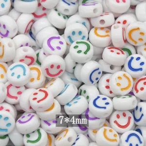 Close-up detail of white acrylic smiley face flat beads, perfect for DIY jewelry making crafts.