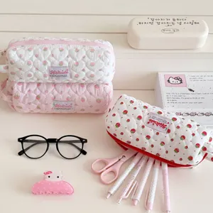 Detailed view of cute strawberry quilted pencil case with soft padding and sweet design.