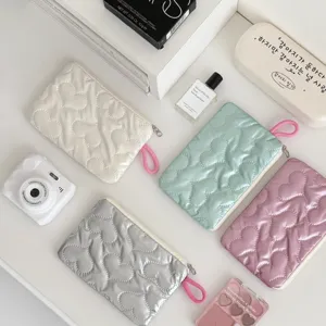 Detail shot of cute quilted heart storage bags in various pastel colors for daily use.
