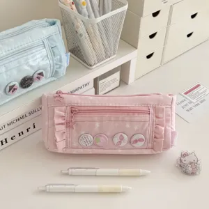 Detail shot of pink star pencil pouch with cute ruffles, displayed on a tidy desk setup.