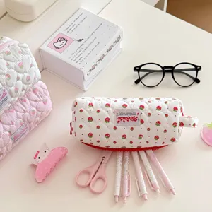 Detail shot of the cute strawberry quilted pencil pouch, highlighting soft fabric and details.