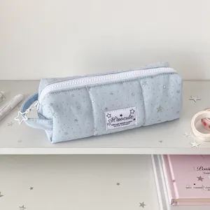Close-up detail of the cute light blue star-patterned canvas pencil case with zipper.