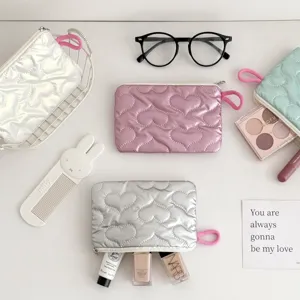 Quilted heart makeup pouch detail showcasing soft padded texture and neat zipper closure.